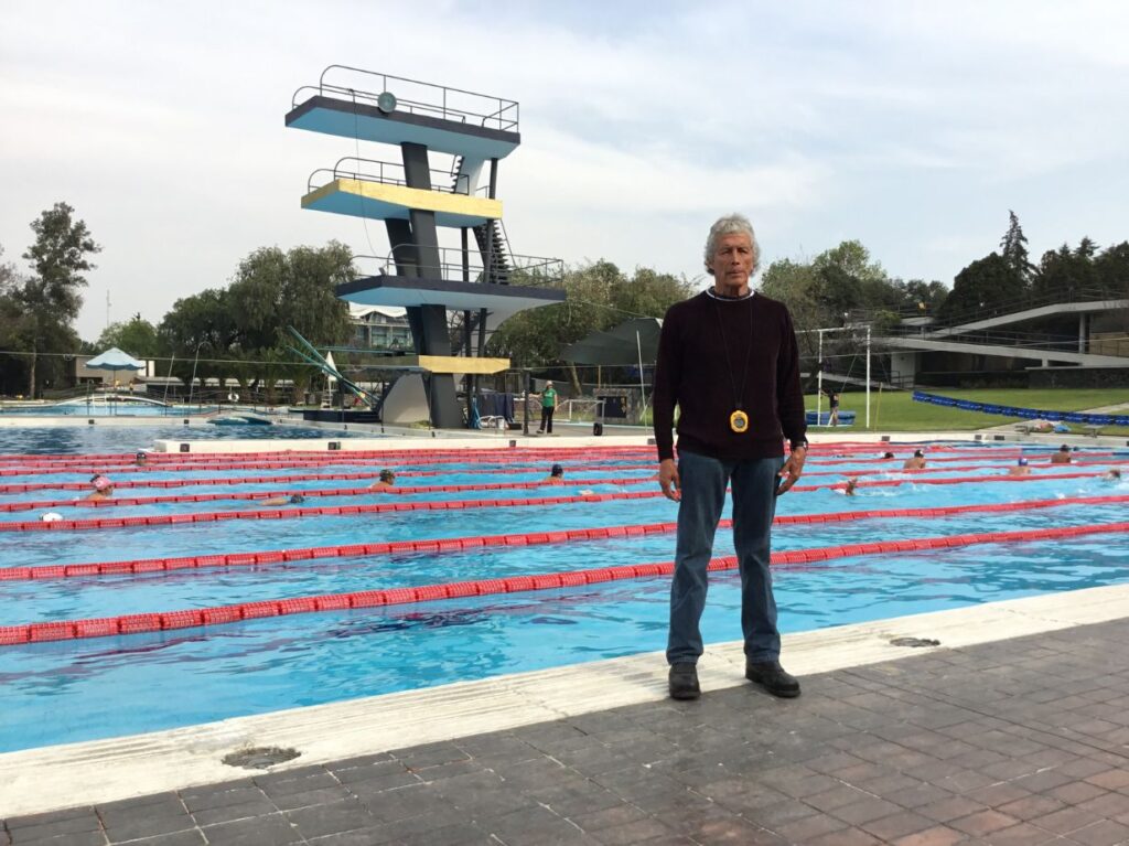 Felipe Muñoz, uno de los nadadores mexicanos más legendarios, de pie frente a una piscina